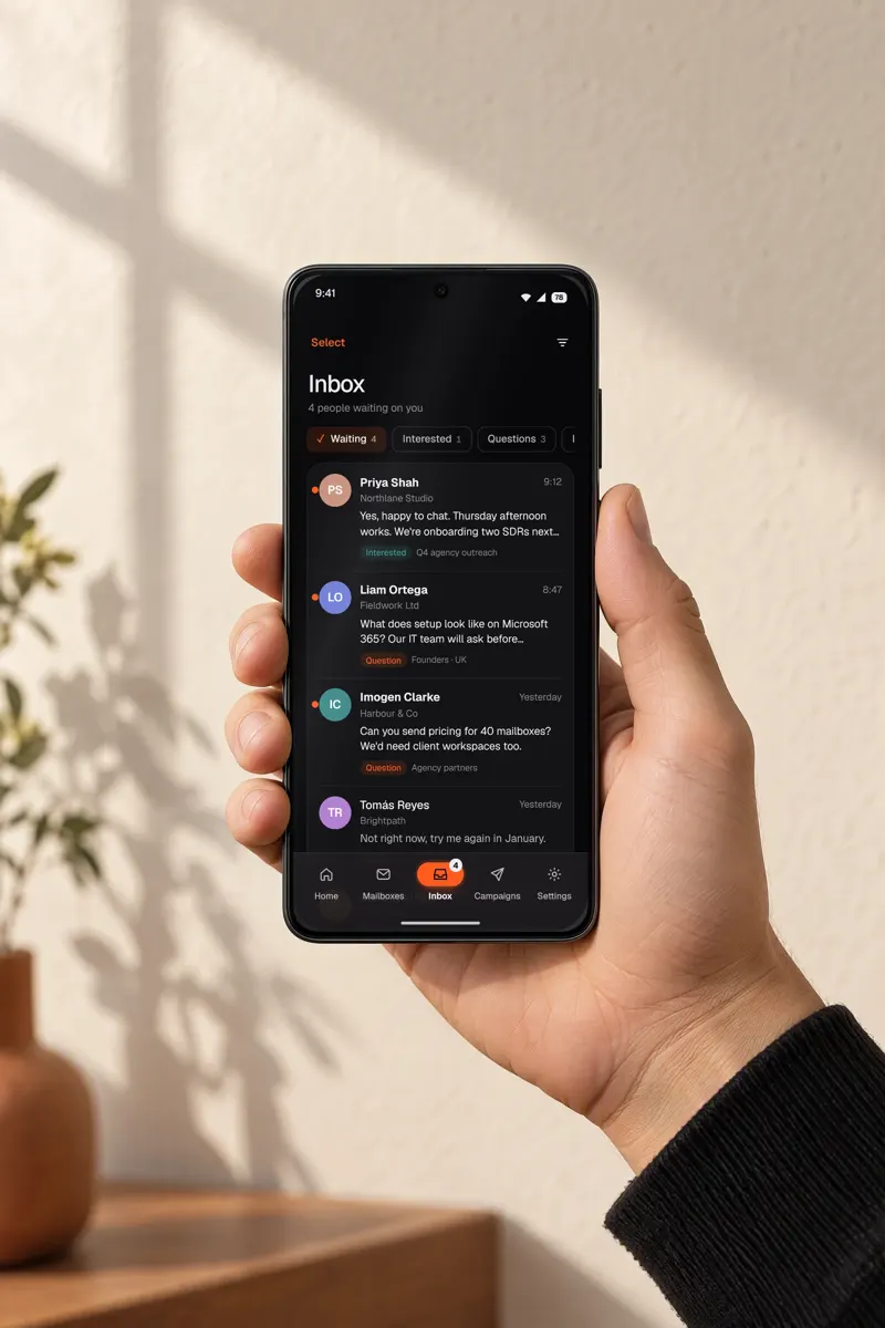 A hand holding a phone showing the Warmerly reply inbox, a design render with sample data