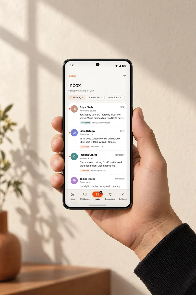 A hand holding a phone showing the Warmerly reply inbox, a design render with sample data
